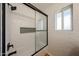 Modern shower boasts white tile, black hardware, and a convenient niche for storage at 4202 E Catalina Dr, Phoenix, AZ 85018