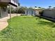 Spacious backyard featuring a well-maintained lawn, privacy fence, and a convenient storage shed at 4213 N Westview Dr, Phoenix, AZ 85015