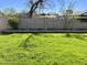 Lush backyard with healthy green grass, a solid block wall, and mature trees at 4213 N Westview Dr, Phoenix, AZ 85015