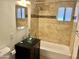 Bathroom featuring a vessel sink, tub and shower combination, and tiled walls at 4213 N Westview Dr, Phoenix, AZ 85015