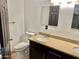 Bathroom featuring dual vanity, tile backsplash, toilet, and mirrors for convenience at 4213 N Westview Dr, Phoenix, AZ 85015