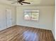 Bright, empty bedroom with neutral paint, laminate wood floors, and a window for natural light at 4213 N Westview Dr, Phoenix, AZ 85015