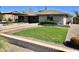 View of the home with manicured green lawn and desert landscaping at 4213 N Westview Dr, Phoenix, AZ 85015