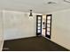 Bright living room featuring white walls and unique light fixture; opens to kitchen area at 4213 N Westview Dr, Phoenix, AZ 85015