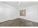 Cozy bedroom offers hardwood floors, a bright window, and a spacious closet, creating a welcoming atmosphere at 4455 E Marshall Ave, Gilbert, AZ 85297