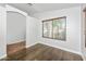 Cozy bedroom with wood floors, a window, and neutral paint at 4455 E Marshall Ave, Gilbert, AZ 85297