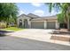 Single-story home with a three-car garage, tile roof, and well-maintained front lawn at 4455 E Marshall Ave, Gilbert, AZ 85297