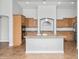 Open kitchen featuring a center island, stainless steel appliances, and wood cabinets at 4455 E Marshall Ave, Gilbert, AZ 85297