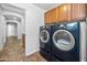Convenient laundry area with front-loading washer and dryer and overhead cabinets at 4455 E Marshall Ave, Gilbert, AZ 85297
