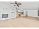 Living room that flows into kitchen featuring fireplace, and neutral colors at 4455 E Marshall Ave, Gilbert, AZ 85297