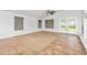 Bright living room features large windows, ceiling fan, and neutral tones, seamlessly connecting indoor and outdoor spaces at 4455 E Marshall Ave, Gilbert, AZ 85297