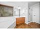 Elegant main bathroom boasts a soaking tub, spacious vanity, and glass-enclosed shower, offering a luxurious retreat at 4455 E Marshall Ave, Gilbert, AZ 85297