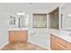 Well-lit main bathroom includes a soaking tub, dual vanities, and contemporary fixtures, enhancing relaxation at 4455 E Marshall Ave, Gilbert, AZ 85297