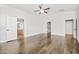 Expansive main bedroom with wood floors, ceiling fan, and a neutral palette create a welcoming and comfortable atmosphere at 4455 E Marshall Ave, Gilbert, AZ 85297