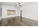 Spacious main bedroom offers wood floors, large window, ceiling fan, and neutral colors providing a serene retreat at 4455 E Marshall Ave, Gilbert, AZ 85297