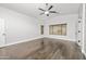 Generous main bedroom showcases hardwood floors, abundant natural light, and a modern ceiling fan, ensuring comfort at 4455 E Marshall Ave, Gilbert, AZ 85297
