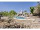 Backyard featuring a pool, surrounded by mature landscaping, and a patio area at 4627 E Mcneil St, Phoenix, AZ 85044