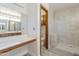 A modern bathroom features wood cabinets, a tiled shower, and vanity area at 4627 E Mcneil St, Phoenix, AZ 85044