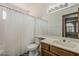 Well-lit bathroom with a shower and tub combo and a large vanity mirror at 4627 E Mcneil St, Phoenix, AZ 85044