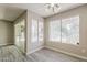This bedroom has wood look floors, two windows, and a sliding glass door to the exterior at 4627 E Mcneil St, Phoenix, AZ 85044