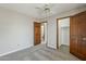 Neutral bedroom features carpet, ceiling fan, and views to bathroom and closet at 4627 E Mcneil St, Phoenix, AZ 85044