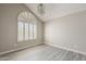Bright bedroom featuring a large window with shutters and gray laminate flooring at 4627 E Mcneil St, Phoenix, AZ 85044