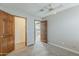 Bedroom featuring a ceiling fan and doors to closet and access to another room at 4627 E Mcneil St, Phoenix, AZ 85044