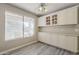 Dining area with built in cabinets next to the big window. Gray laminate flooring at 4627 E Mcneil St, Phoenix, AZ 85044