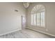 Bright dining room with a chandelier, arched window, and gray laminate flooring at 4627 E Mcneil St, Phoenix, AZ 85044