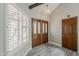 Welcoming entryway featuring double doors, laminate flooring, white trim, and natural light at 4627 E Mcneil St, Phoenix, AZ 85044