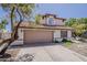 Charming two-story home with a tan garage door, tile roof, and well-maintained landscaping at 4627 E Mcneil St, Phoenix, AZ 85044