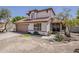 Charming two-story home with a tile roof and mature trees surrounding the property at 4627 E Mcneil St, Phoenix, AZ 85044