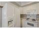 Kitchen features white cabinets and appliances, with white refrigerator and stove at 4627 E Mcneil St, Phoenix, AZ 85044