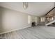 Open living room with fireplace and a staircase with grey laminate flooring at 4627 E Mcneil St, Phoenix, AZ 85044