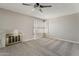 This living room offers neutral colors, carpeted floors, fireplace and shutters on the windows at 4627 E Mcneil St, Phoenix, AZ 85044