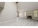 Open living room featuring a fireplace, high ceilings, and gray laminate flooring at 4627 E Mcneil St, Phoenix, AZ 85044