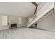 Bright living room with high ceilings, gray floors, fireplace, and a staircase at 4627 E Mcneil St, Phoenix, AZ 85044