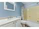 Updated bathroom with white vanity, framed mirror, and a shower-tub combination at 4911 E Holmes Ave, Mesa, AZ 85206