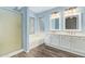 Well-lit bathroom features double vanity sinks, storage, bathtub, and separate glass enclosed shower at 4911 E Holmes Ave, Mesa, AZ 85206
