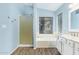 Beautiful bathroom with a glass-enclosed shower, soaking tub, and dual sink vanity with white cabinets at 4911 E Holmes Ave, Mesa, AZ 85206