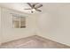 Bright bedroom features a window for natural light and a ceiling fan for added comfort at 4911 E Holmes Ave, Mesa, AZ 85206