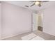 Bedroom with carpet, ceiling fan, and an open door, offers a cozy and inviting space at 4911 E Holmes Ave, Mesa, AZ 85206