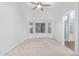 Inviting bedroom features neutral carpet, a ceiling fan, and bay window with exterior views at 4911 E Holmes Ave, Mesa, AZ 85206