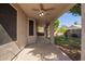 A covered patio with a ceiling fan, offering a relaxing outdoor space with access to backyard at 4911 E Holmes Ave, Mesa, AZ 85206