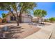 Street view showcasing a single-story home with desert landscaping, two-car garage, and a paved walkway at 4911 E Holmes Ave, Mesa, AZ 85206