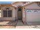 Close-up showcasing the front door and two-car garage with the address number on a well-maintained single-story home at 4911 E Holmes Ave, Mesa, AZ 85206