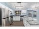 Modern kitchen featuring stainless steel appliances, white cabinets, granite countertops, and a kitchen island at 4911 E Holmes Ave, Mesa, AZ 85206