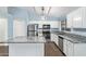 Modern kitchen with white cabinets, stainless steel appliances, granite counters, and a center kitchen island at 4911 E Holmes Ave, Mesa, AZ 85206