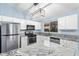 Well-lit kitchen with stainless steel appliances, white cabinets, granite countertops, and an island with seating at 4911 E Holmes Ave, Mesa, AZ 85206