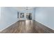 Spacious living room with wood-look tile floors, vaulted ceiling, and sliding glass door leading to outdoor space at 4911 E Holmes Ave, Mesa, AZ 85206
